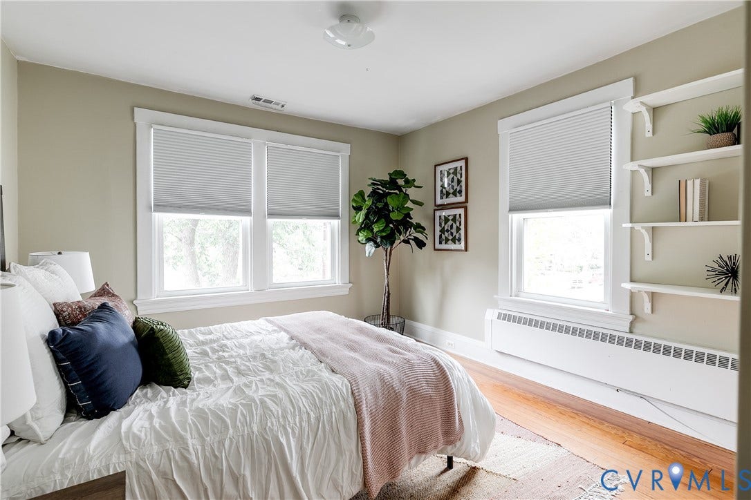 4015 Mount Vernon Street, Bellevue, Richmond, VA 23227 Bright, sun-filled bedroom with dual windows featuring cellular shades, hardwood flooring, and built-in shelving with display space