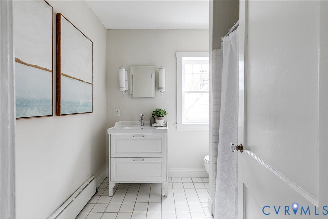 4015 Mount Vernon Street, Bellevue, Richmond, VA 23227 White vanity with integrated sink, chrome faucet, and storage drawers