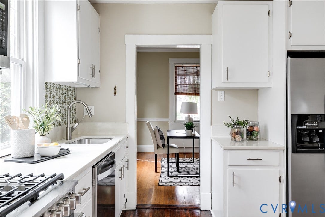4015 Mount Vernon Street, Bellevue, Richmond, VA 23227 White cabinetry with brushed nickel hardware, light-toned countertops, stainless steel sink with gooseneck faucet, and a stainless steel refrigerator