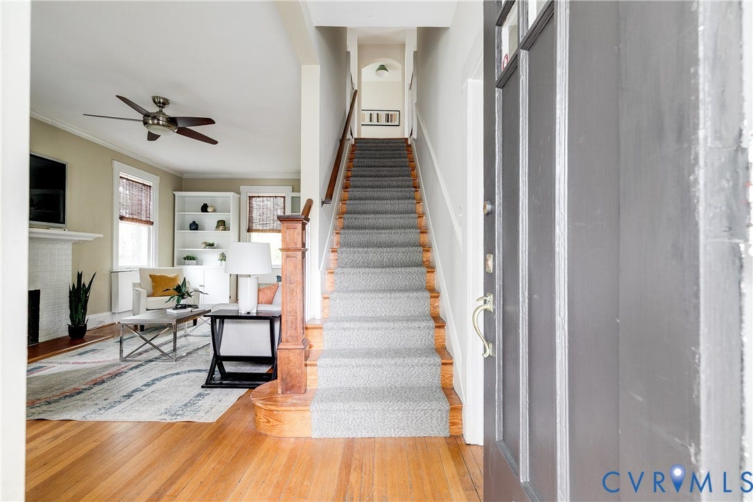 4015 Mount Vernon Street, Bellevue, Richmond, VA 23227 Warm wood flooring, a carpeted staircase with wood banister, built-in shelving, and a ceiling fan with integrated lighting