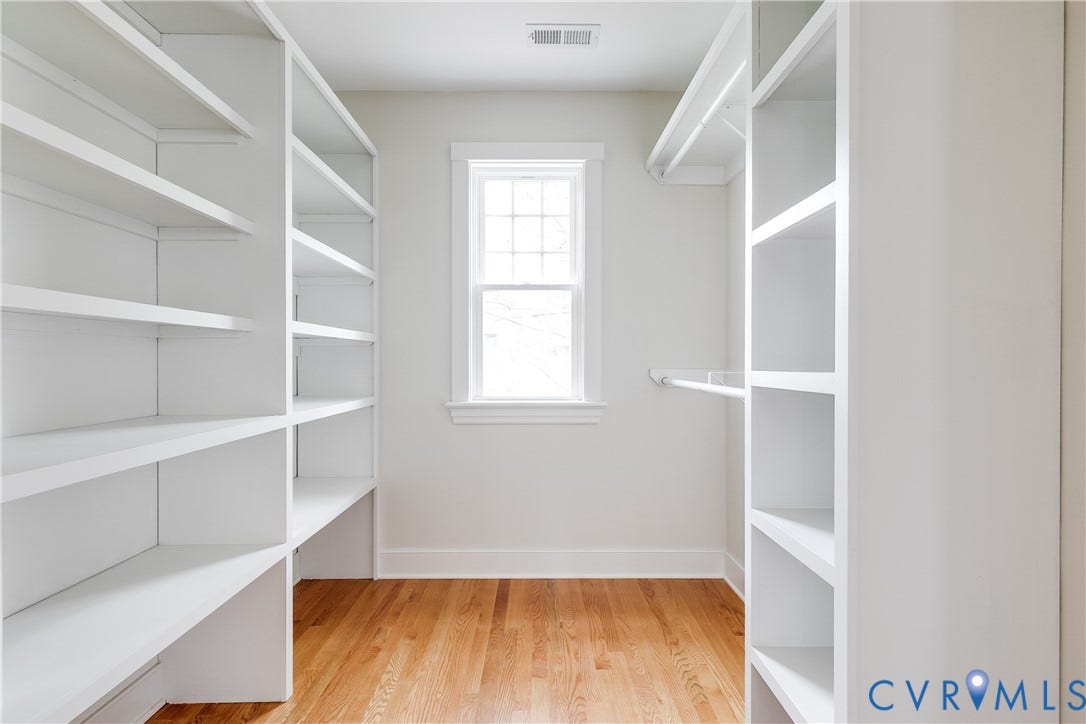 4015 Mount Vernon Street, Bellevue, Richmond, VA 23227 Built-in shelving, hanging rods, wood flooring, and natural light from a double-hung window