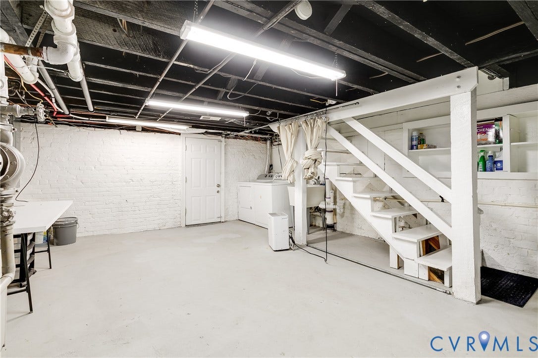 4015 Mount Vernon Street, Bellevue, Richmond, VA 23227 Utility basement space featuring exposed ceiling joists, white painted brick walls, a built-in staircase, and a utility sink