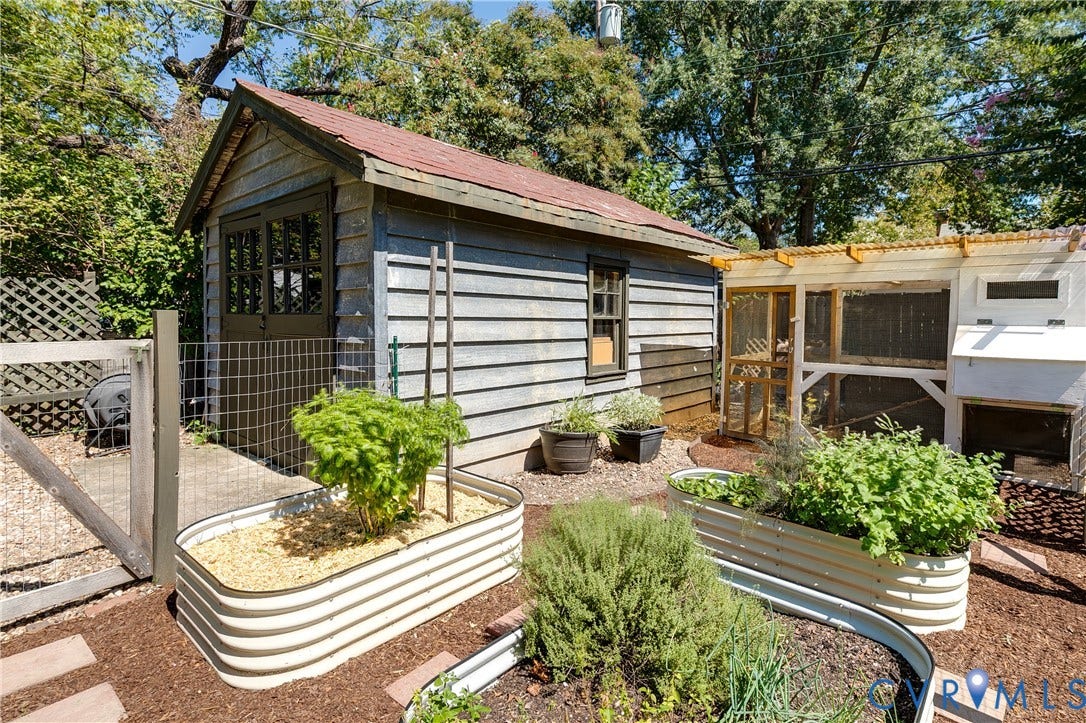 4015 Mount Vernon Street, Bellevue, Richmond, VA 23227 Wood-sided shed with a gable roof, adjacent to a structured enclosure with a corrugated roof