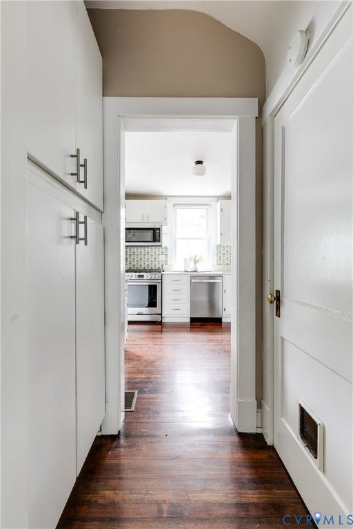 4015 Mount Vernon Street, Bellevue, Richmond, VA 23227 Expansive hardwood flooring extending into kitchen, white kitchen cabinetry, pantry storage and stainless steel appliances
