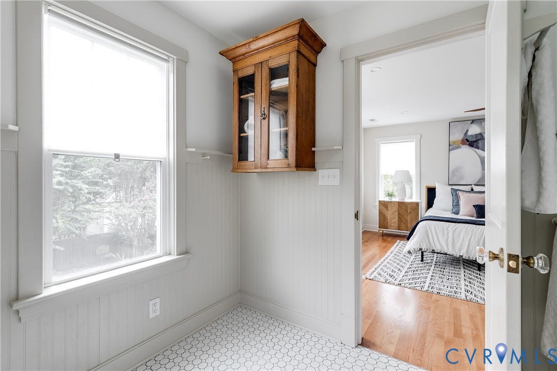 4015 Mount Vernon Street, Bellevue, Richmond, VA 23227 Hexagonal tile flooring, beadboard wall paneling, built-in wooden cabinetry, window with roller shade, and a door with clear glass knob