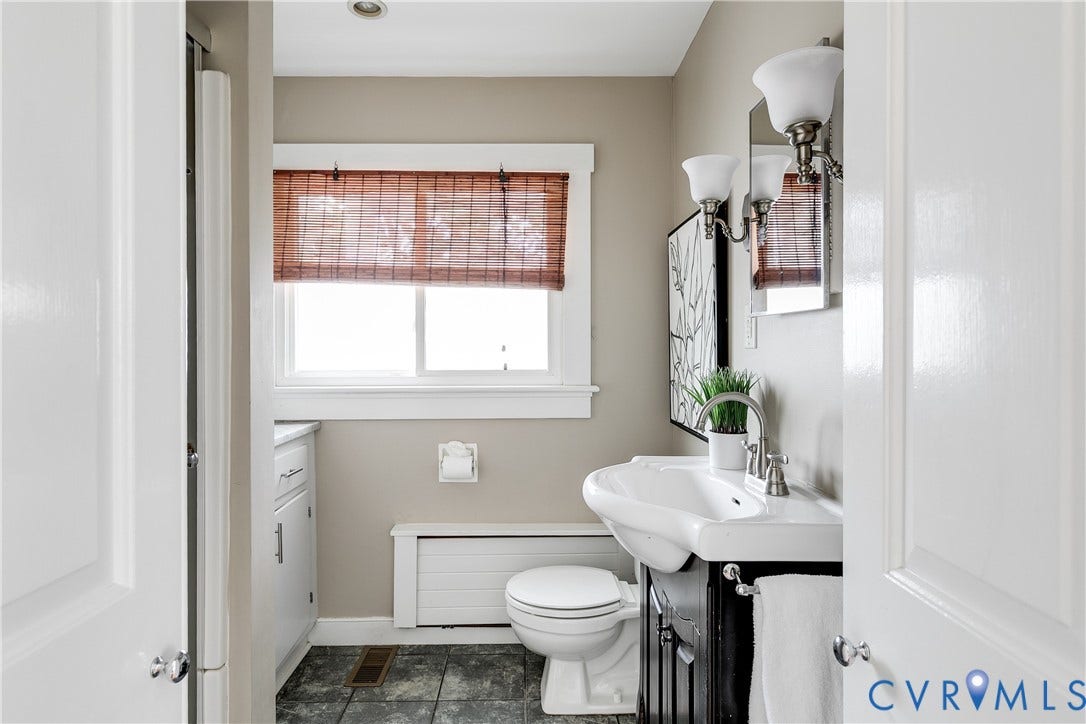 4015 Mount Vernon Street, Bellevue, Richmond, VA 23227 Recessed ceiling light, white window trim, dual-sconce wall lighting, and dark wood vanity sink