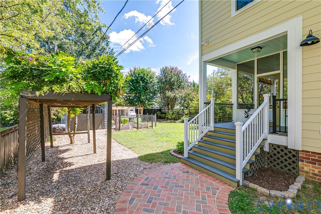 4015 Mount Vernon Street, Bellevue, Richmond, VA 23227 Screened porch with light blue ceiling, wood pergola, brick paver path, gravel landscaping, and green lawn area