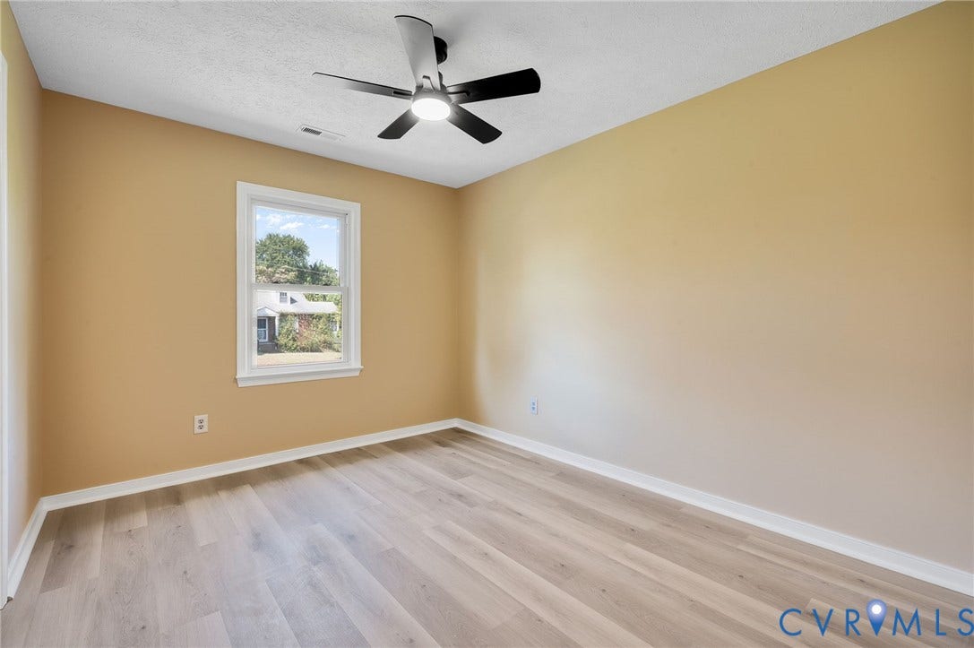 4411 Samara Drive, Henrico, VA 23231 Wood-finish flooring with crisp white trim, a modern ceiling fan, and a single window with white framing