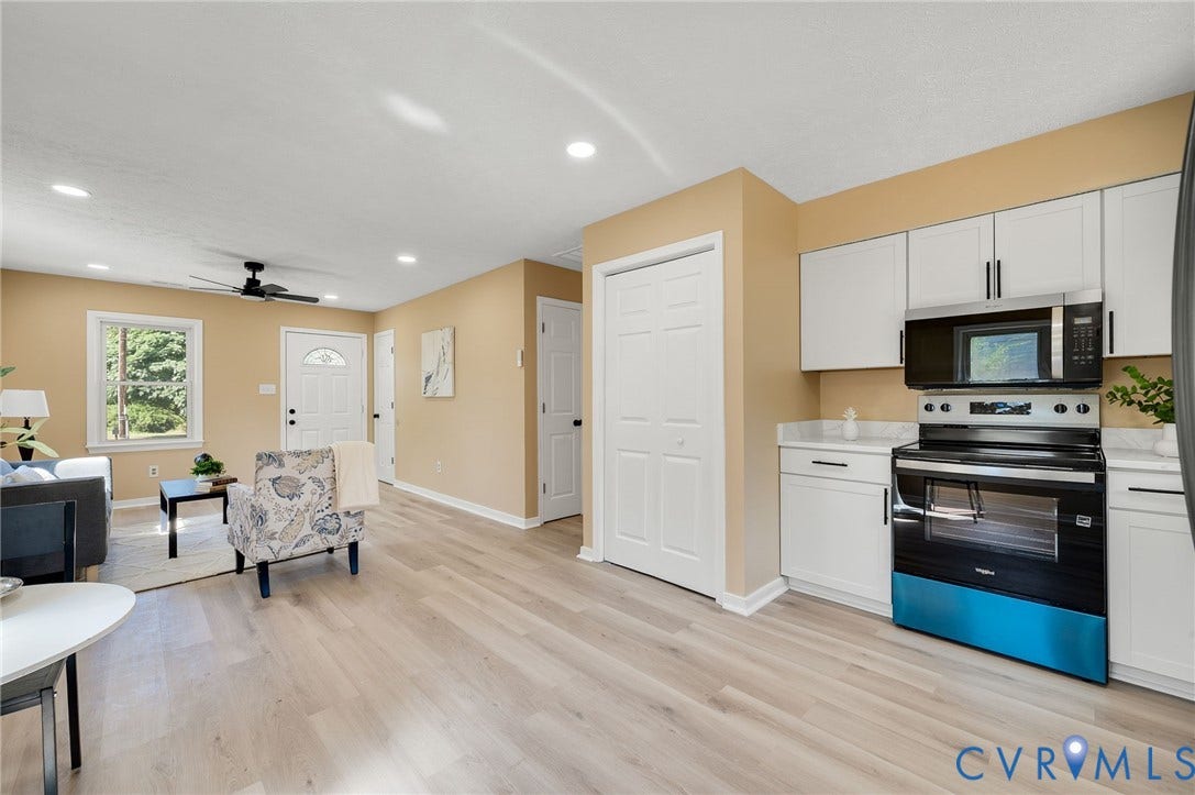 4411 Samara Drive, Henrico, VA 23231 Wood-finish flooring throughout, recessed lighting, white kitchen cabinetry, stainless steel and black appliances, and a ceiling fan