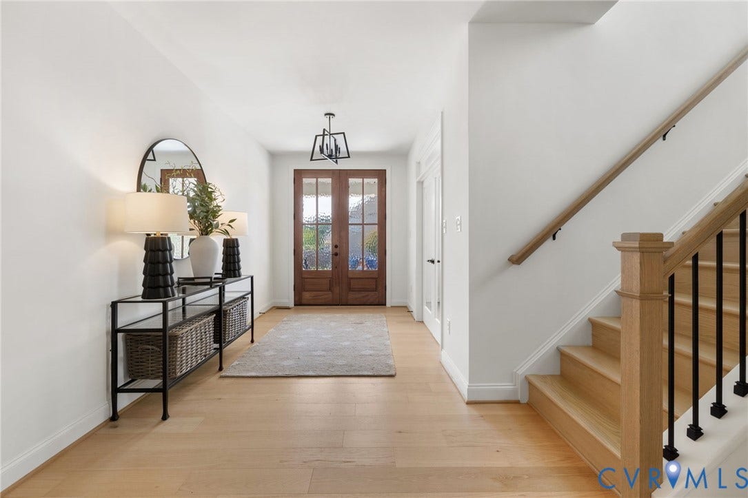 2871 Old Pump Road, The Preserve At John Rolfe, Henrico, VA 23233 Light wood-finish flooring, white walls, wood double entry doors, wood staircase with black iron spindles, and a modern ceiling fixture