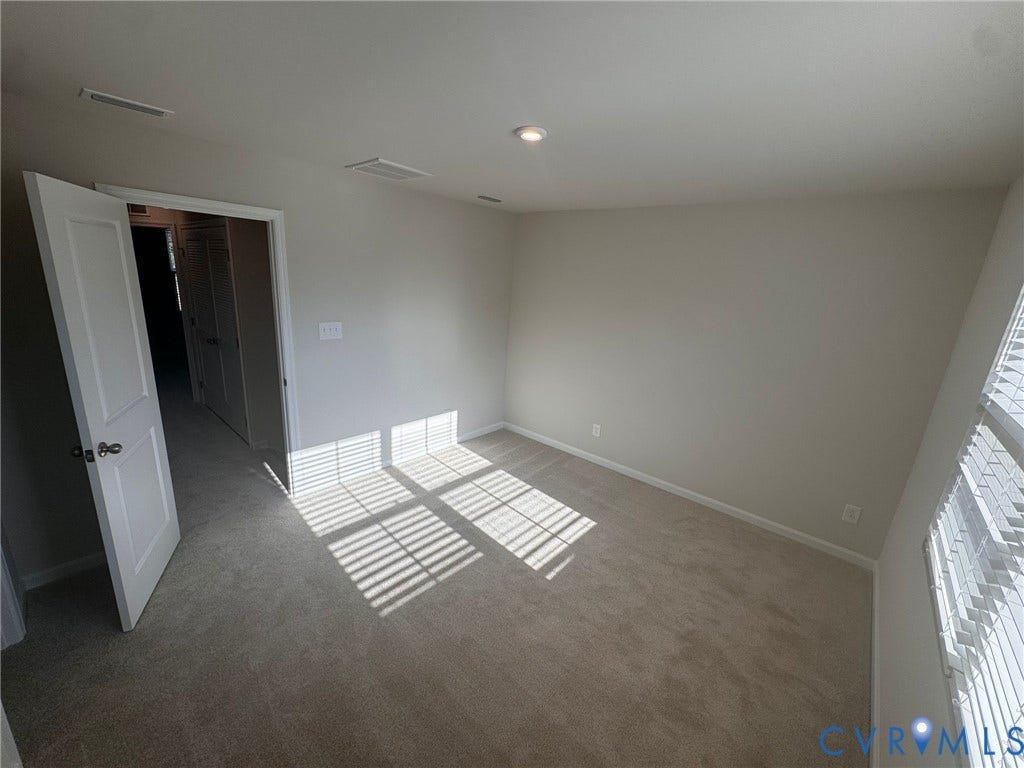 Carpeted room with recessed lighting, neutral wall paint, and white trim