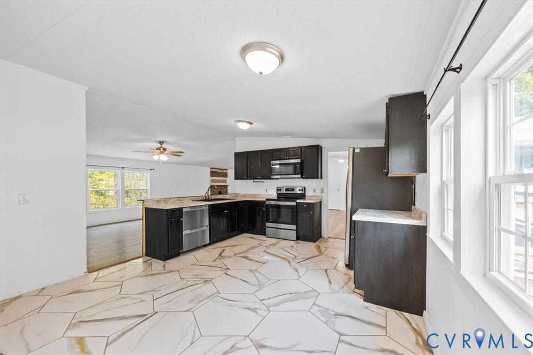 274 Frenchs Store Road, Cumberland, VA 23040 Kitchen featuring dark cabinetry, stone-finish countertops, stainless steel appliances, and large-format geometric marble tile flooring