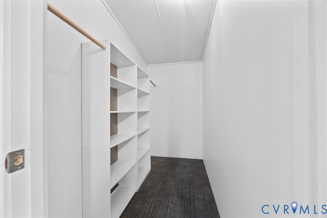 274 Frenchs Store Road, Cumberland, VA 23040 Walk-in closet featuring white built-in shelving and dual hanging rods