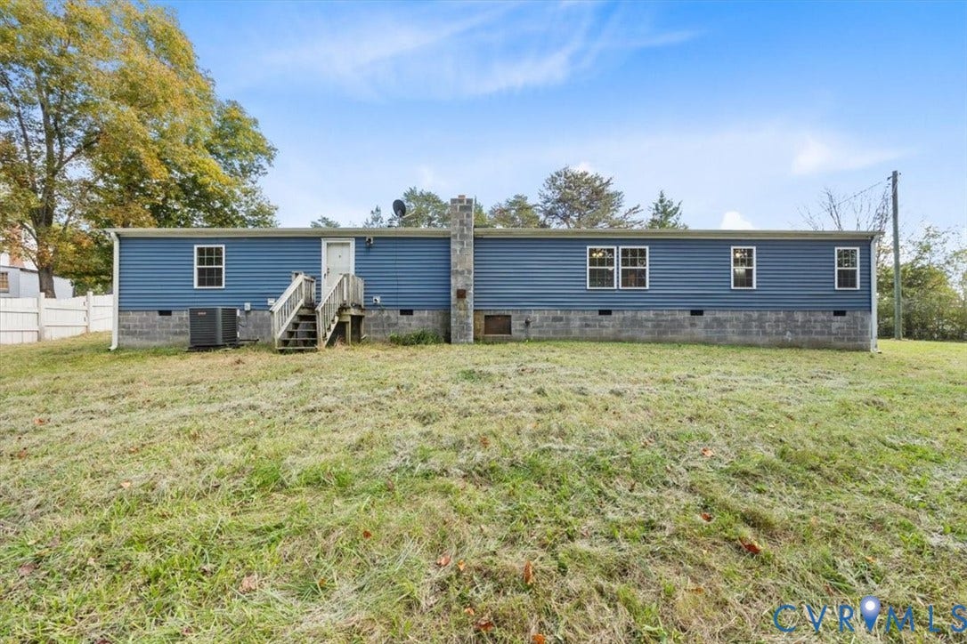 274 Frenchs Store Road, Cumberland, VA 23040 Exterior featuring horizontal siding, a stone-veneer chimney, concrete block foundation, wooden stairs, and a level lawn