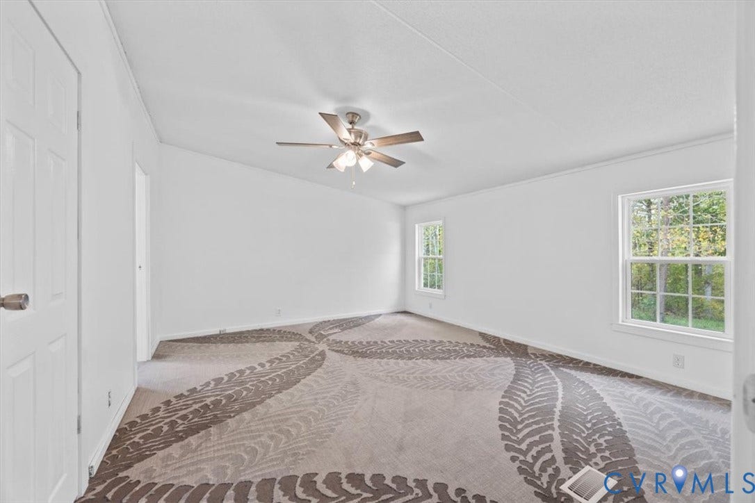 274 Frenchs Store Road, Cumberland, VA 23040 Interior room featuring patterned wall-to-wall carpeting, brushed-nickel ceiling fan with integrated lighting, and multiple windows