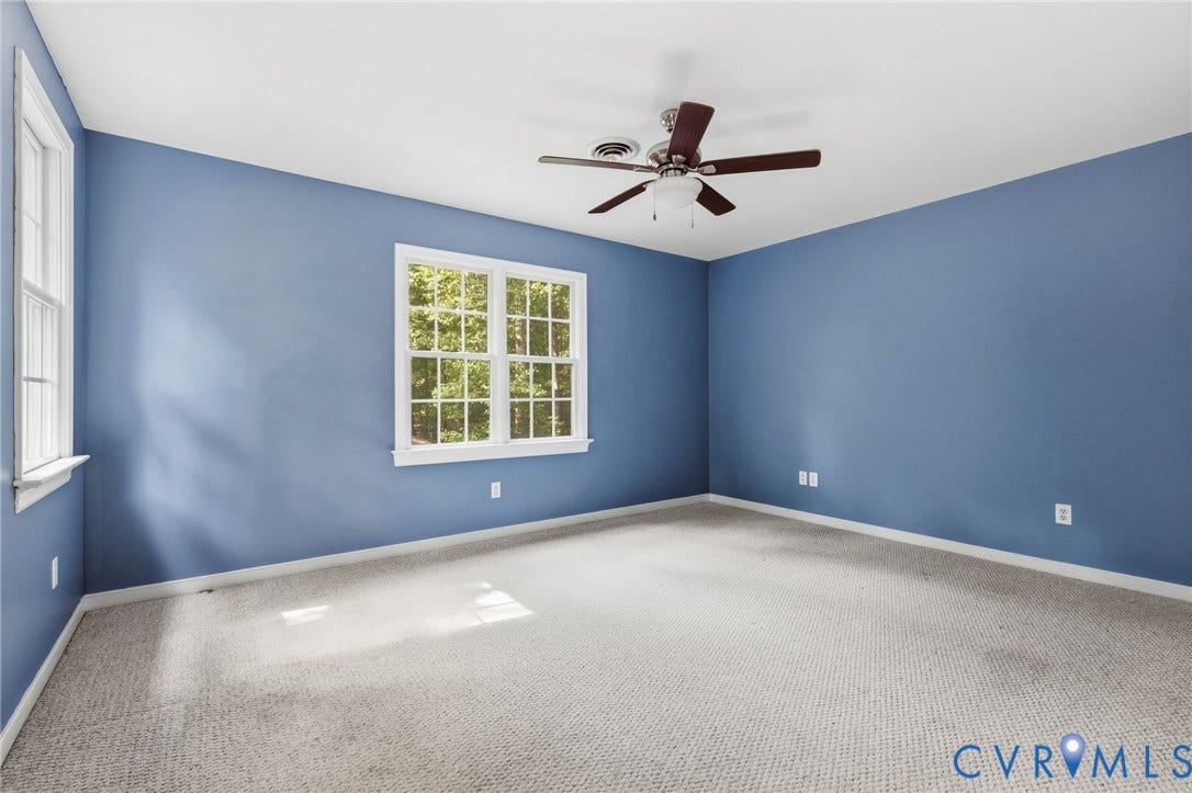 4350 Steger Creek Drive, Powhatan, VA 23139 Two multi-pane windows, light neutral-toned carpet, a ceiling fan with integrated lighting, and painted walls
