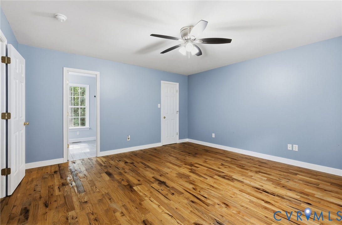 4350 Steger Creek Drive, Powhatan, VA 23139 Wood-finish flooring, light blue wall paint, white trim, and a ceiling fan with integrated lighting