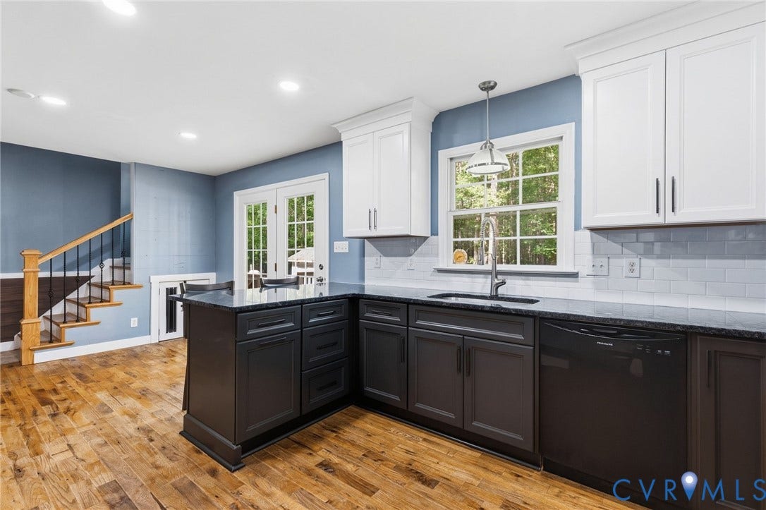 4350 Steger Creek Drive, Powhatan, VA 23139 Kitchen with wood-finish flooring, dark perimeter cabinetry, white upper cabinetry, and a subway tile backsplash