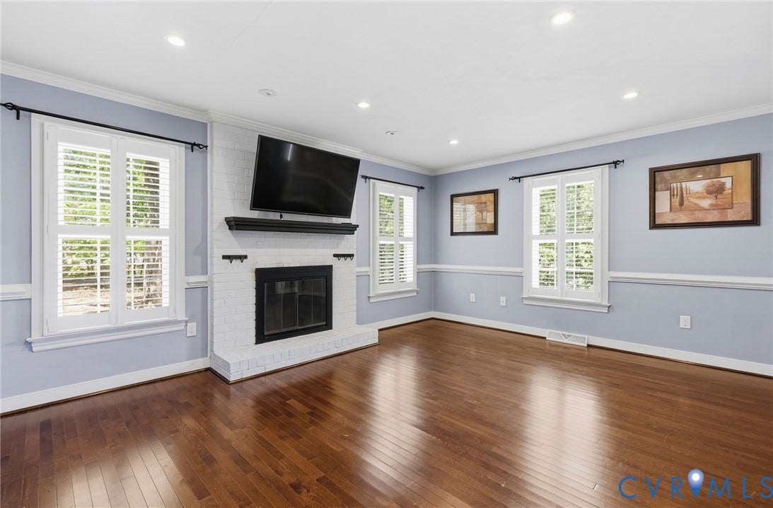 2137 Scarlet Mill Lane, Powhatan, VA 23139 Hardwood flooring, white brick fireplace with mantel, recessed lighting, crown molding, and plantation shutters