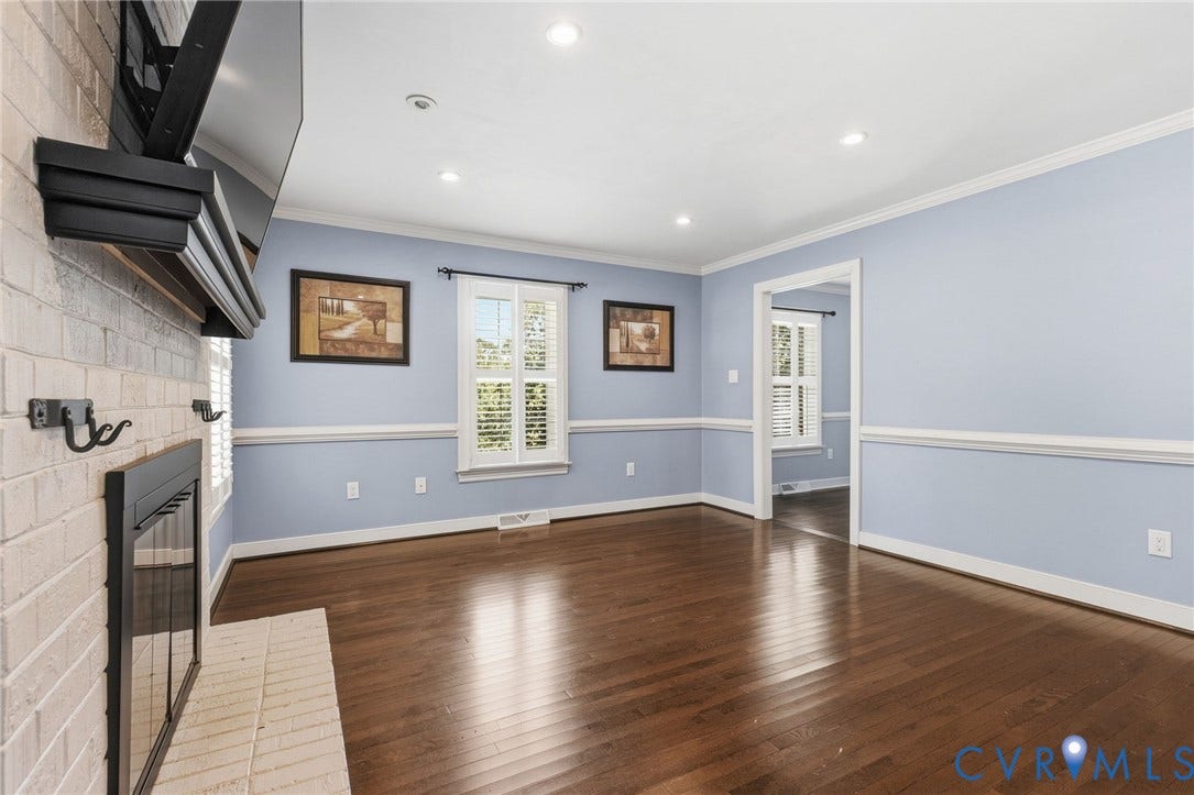 2137 Scarlet Mill Lane, Powhatan, VA 23139 Brick fireplace with hearth, recessed lighting, wood-finish flooring, chair rail molding, and windows with plantation shutters