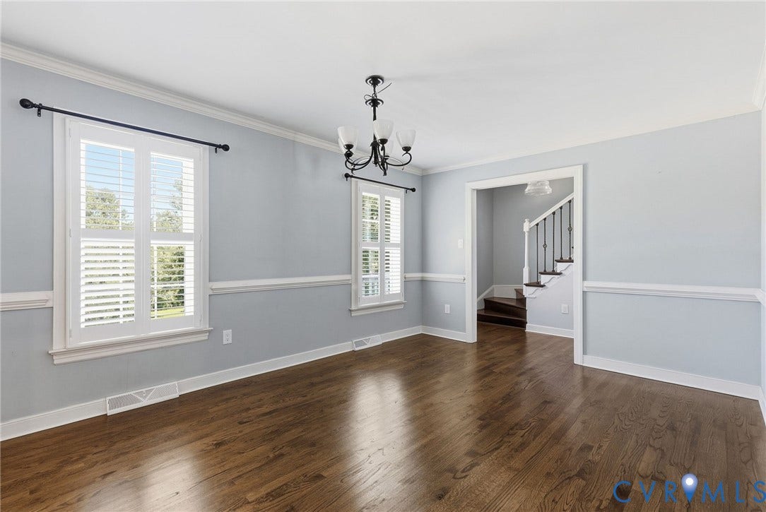 2137 Scarlet Mill Lane, Powhatan, VA 23139 Hardwood flooring, two windows with white plantation shutters, crown molding, wall paneling, and a chandelier
