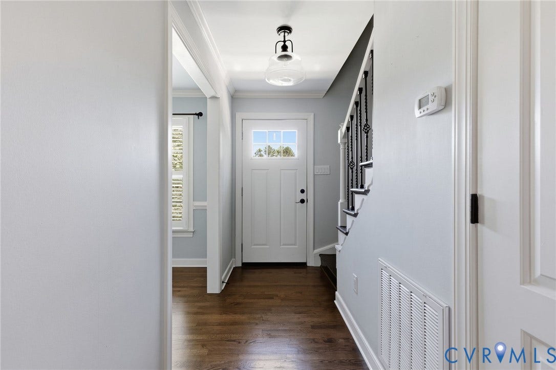 2137 Scarlet Mill Lane, Powhatan, VA 23139 Entryway featuring a paneled door with glass inserts, wood-finish flooring, a staircase with decorative metal balusters, and a ceiling-mounted light fixture