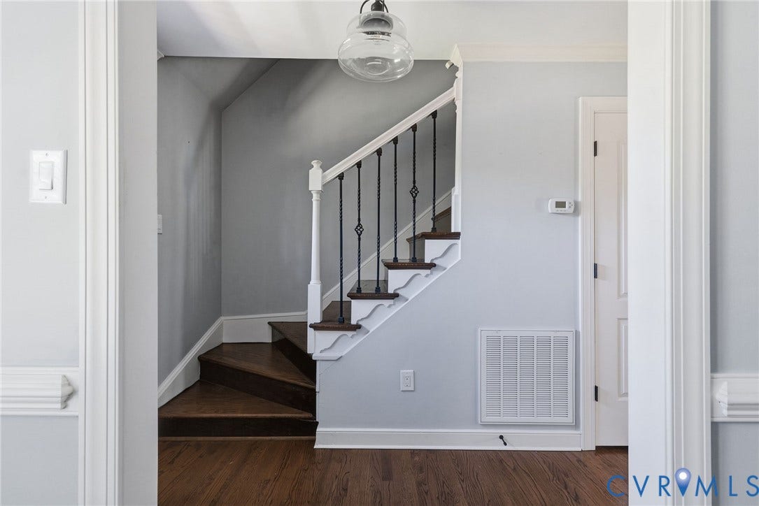 2137 Scarlet Mill Lane, Powhatan, VA 23139 Hardwood flooring and a staircase with dark wood treads, white risers, and wrought iron balusters