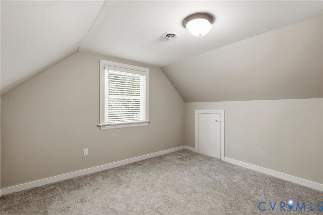 2137 Scarlet Mill Lane, Powhatan, VA 23139 Carpeted room featuring a window with blinds, sloped ceilings, and a built-in storage door