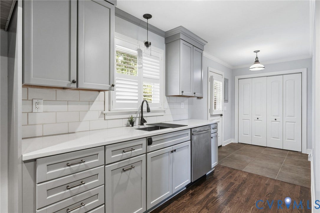 2137 Scarlet Mill Lane, Powhatan, VA 23139 Kitchen featuring gray shaker-style cabinetry, white subway tile backsplash, stainless steel dishwasher, an undermount sink with a black faucet, and wood-finish flooring