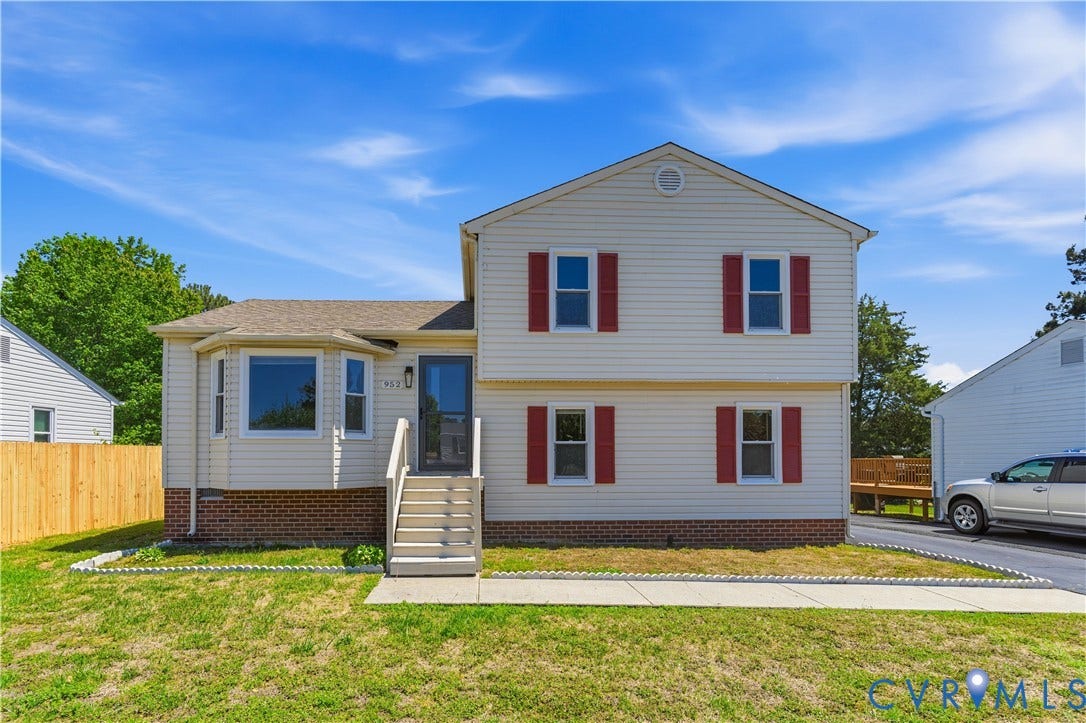 952 Pleasant Street, Henrico, VA 23223 Two-story exterior with siding, brick foundation, bay window, and a wooden privacy fence