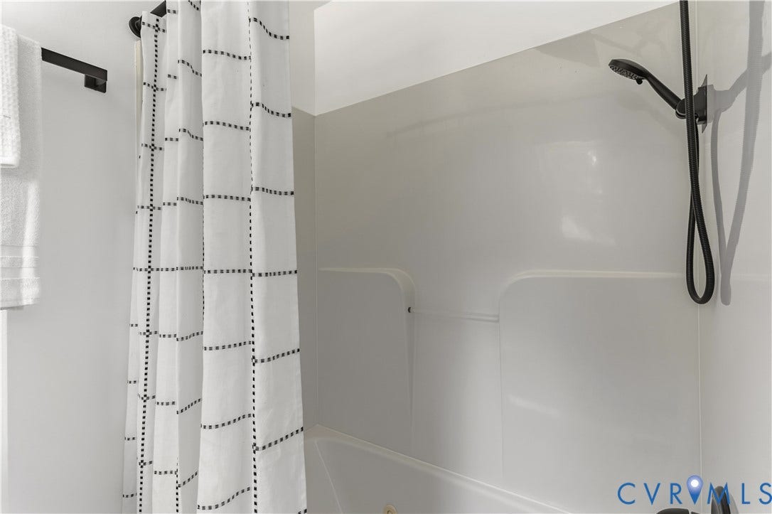952 Pleasant Street, Henrico, VA 23223 Bathtub with an integrated shower, white tub surround, and a matte black shower fixture