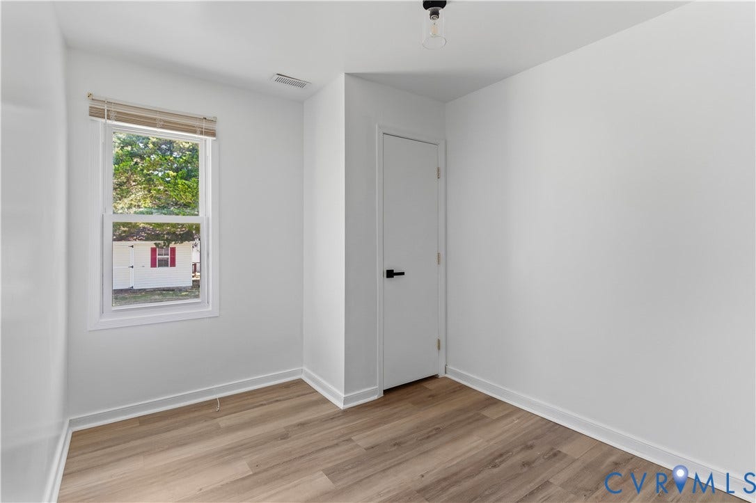 952 Pleasant Street, Henrico, VA 23223 Light wood-finish flooring, white walls, and a white door with black hardware