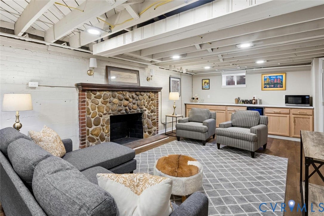 1316 Brookland Parkway, Richmond, VA 23227 Exposed ceiling beams, recessed lighting, stone fireplace with brick surround, built-in cabinetry with solid surface countertop, and wood-finish flooring