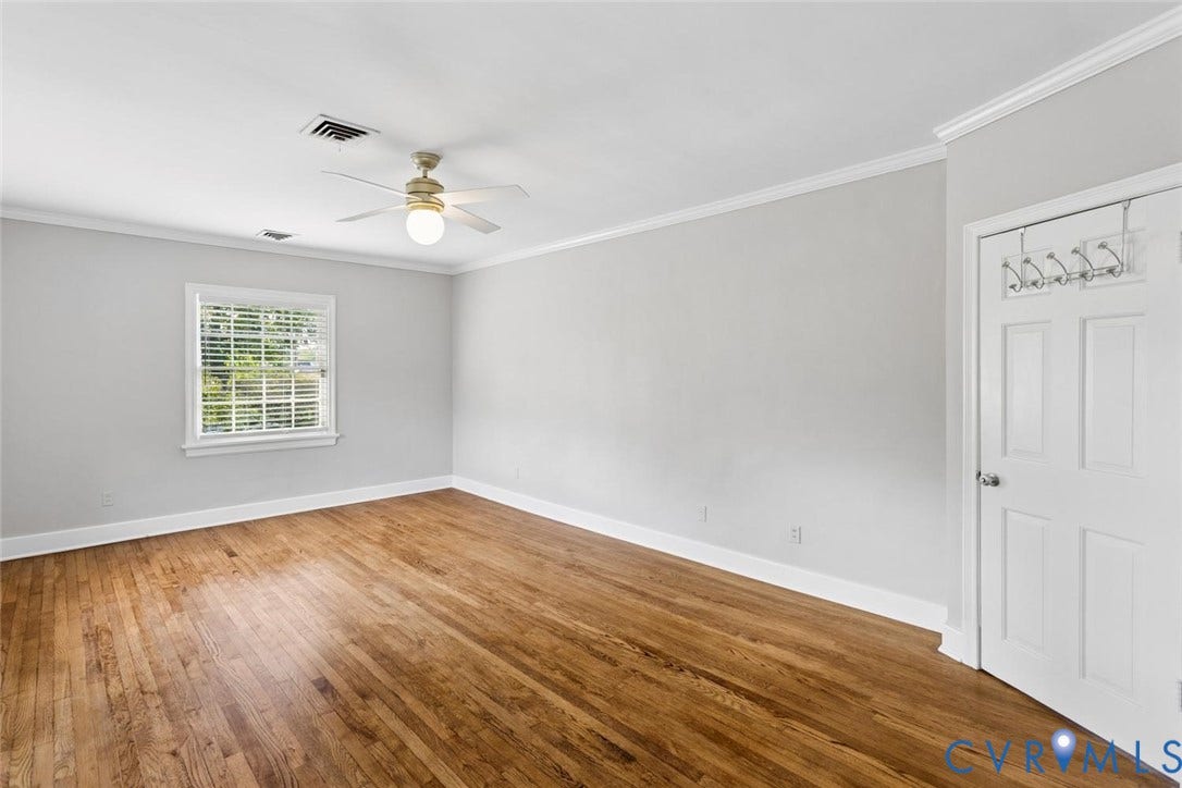 1316 Brookland Parkway, Richmond, VA 23227 Wood-finish flooring, white paneled door, crown molding, a window with blinds, and a ceiling fan with light fixture