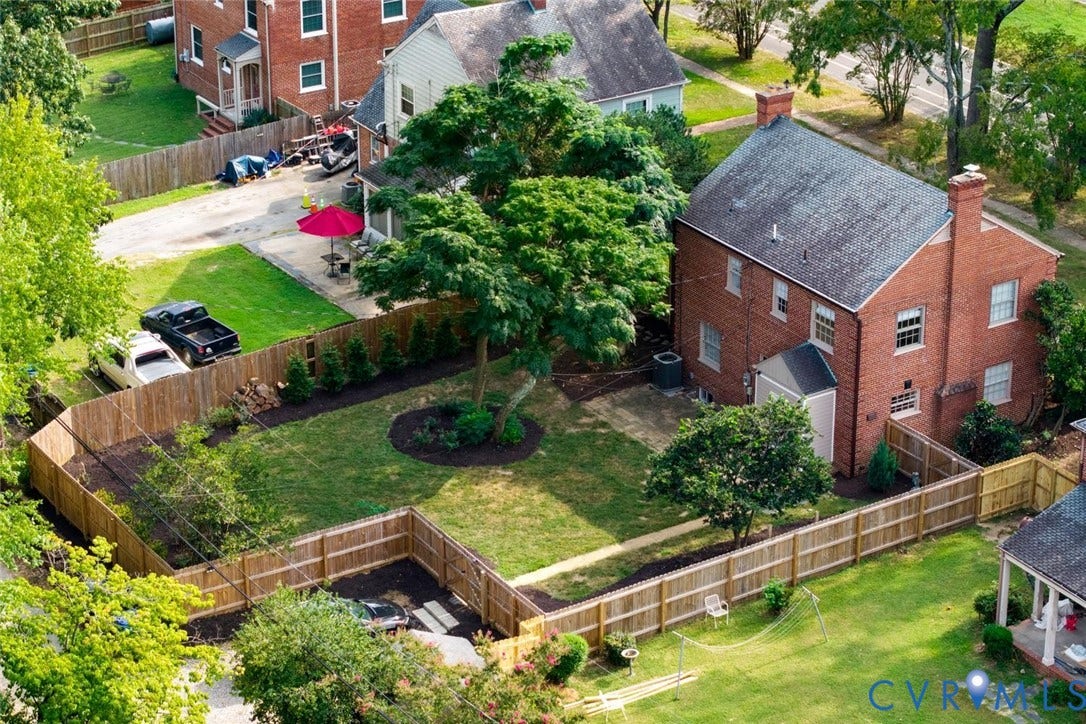 1316 Brookland Parkway, Richmond, VA 23227 Brick exterior home with a gabled roof and two prominent brick chimneys