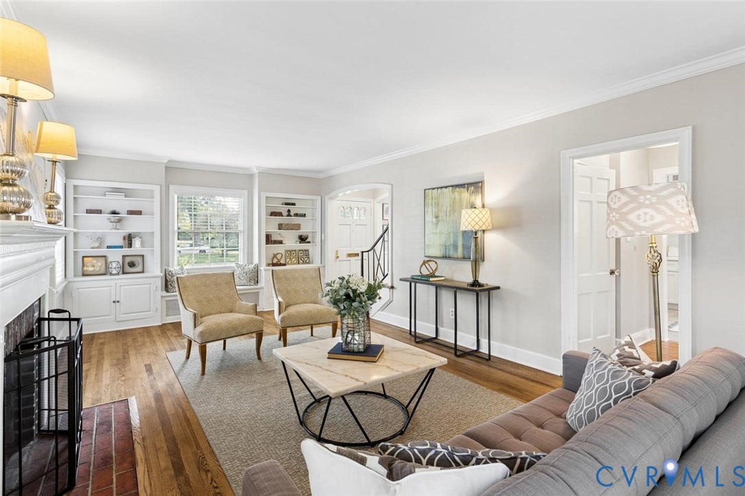 1316 Brookland Parkway, Richmond, VA 23227 Hardwood flooring, crown molding, built-in shelving, a fireplace with a brick hearth, and crisp white trim