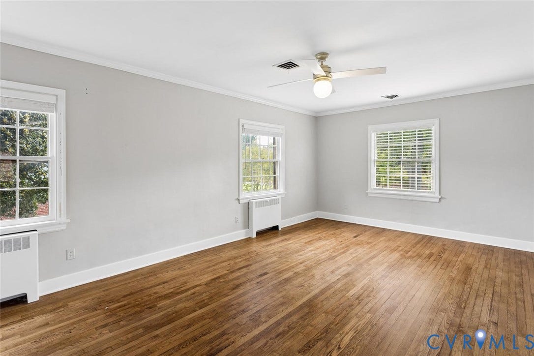 1316 Brookland Parkway, Richmond, VA 23227 Hardwood flooring, two windows, crown molding, ceiling fan with integrated lighting, and neutral wall tones