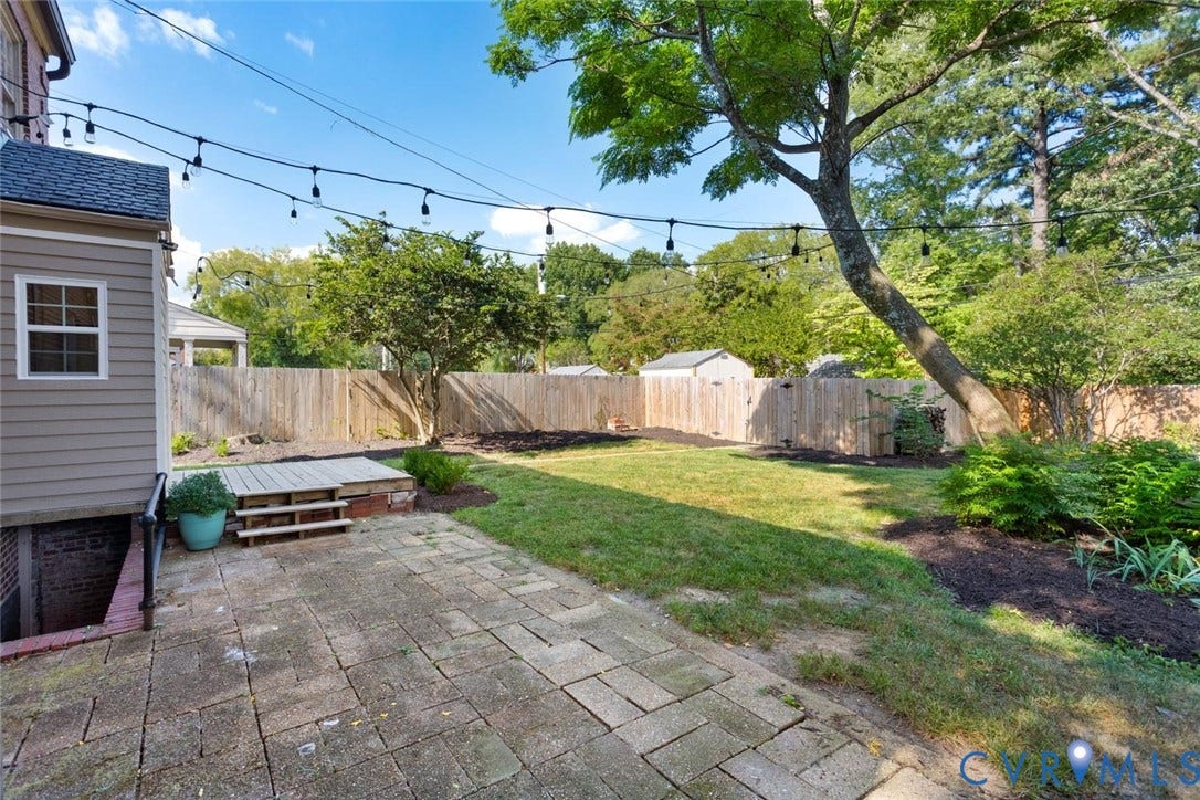1316 Brookland Parkway, Richmond, VA 23227 Expansive backyard featuring a paver patio, wood privacy fence, and mature trees