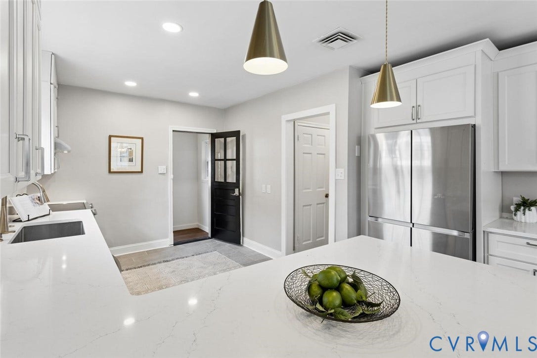 1316 Brookland Parkway, Richmond, VA 23227 White shaker cabinetry, stainless steel refrigerator, white countertops, recessed lighting, and modern pendant light fixtures