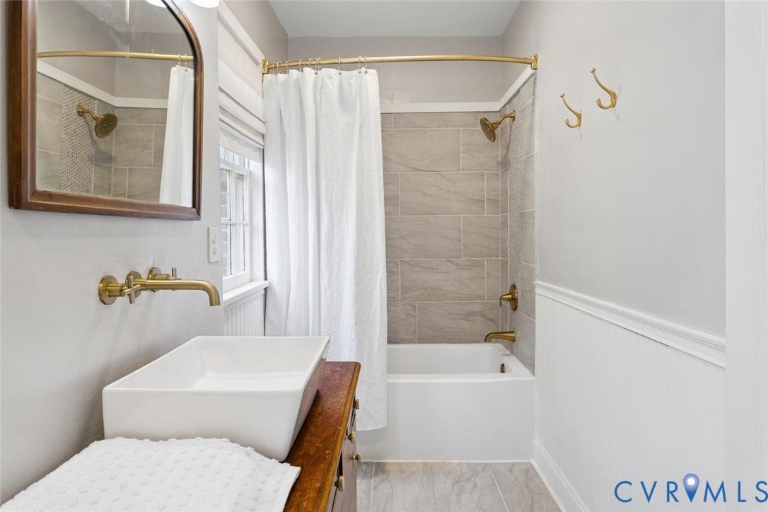 1316 Brookland Parkway, Richmond, VA 23227 Wall-mounted brass faucet with a rectangular vessel sink, set atop a wood-finish vanity