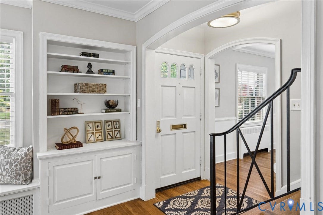 1316 Brookland Parkway, Richmond, VA 23227 Hardwood flooring, arched doorway, built-in shelving, white paneled door with glass inserts, and a wrought iron railing