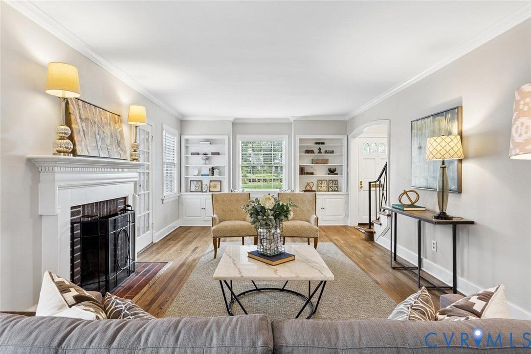 1316 Brookland Parkway, Richmond, VA 23227 Living area featuring a white mantel fireplace, wood-finish flooring, built-in shelving, white trim, and crown molding