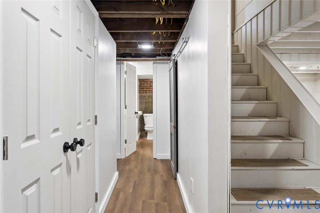 1316 Brookland Parkway, Richmond, VA 23227 Wood-finish flooring, white paneled doors with black hardware, and a white painted staircase