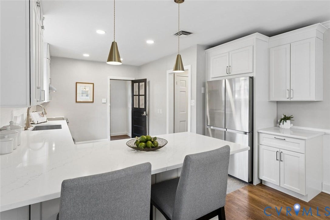 1316 Brookland Parkway, Richmond, VA 23227 White cabinetry, stainless steel refrigerator, recessed lighting, and wood-finish flooring