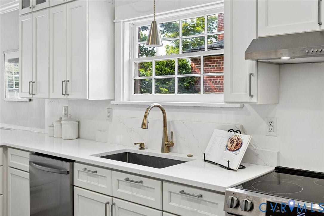 1316 Brookland Parkway, Richmond, VA 23227 White shaker cabinetry, light-colored countertops, undermount sink with gooseneck faucet, stainless steel appliances, and a window with natural light