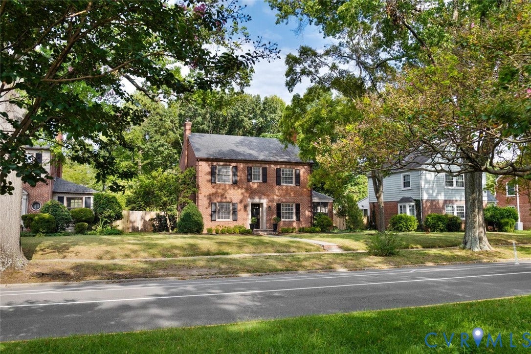 1316 Brookland Parkway, Richmond, VA 23227 Brick exterior with a dark shingle roof, mature trees, and a manicured lawn