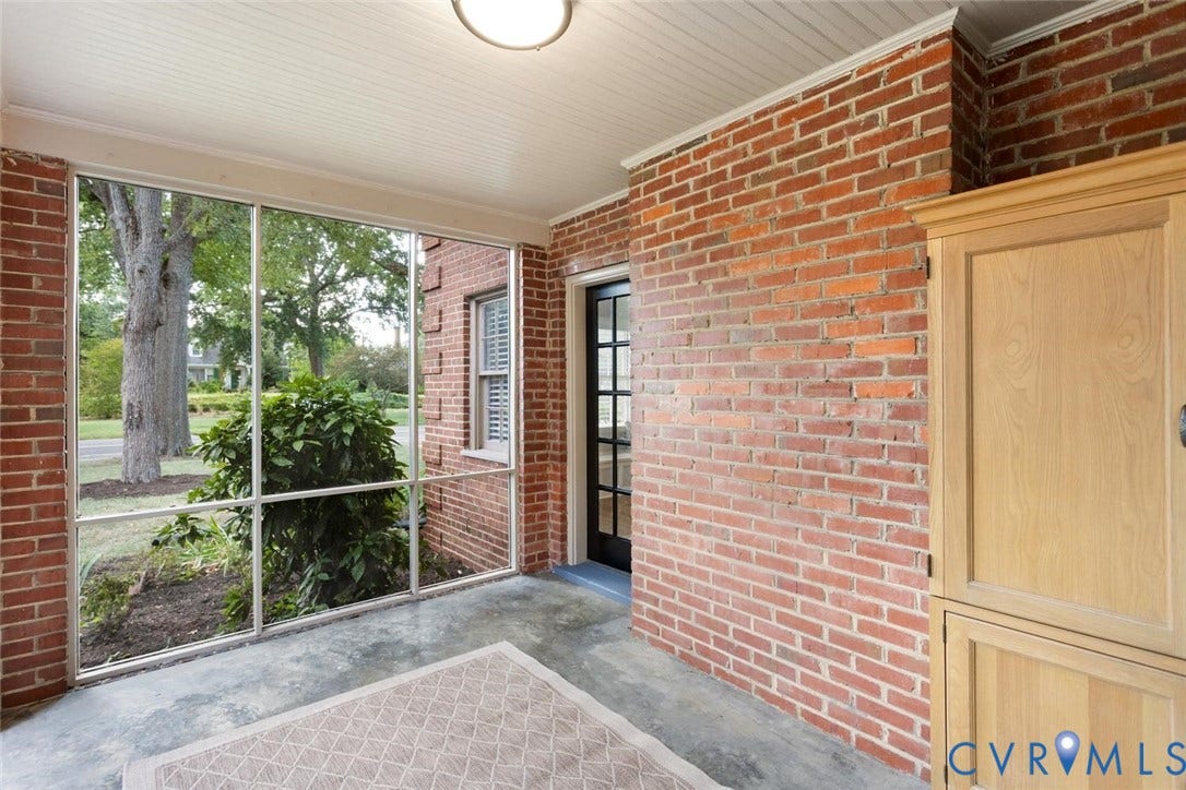 1316 Brookland Parkway, Richmond, VA 23227 Screened porch featuring brick walls, a paneled ceiling, and a concrete floor