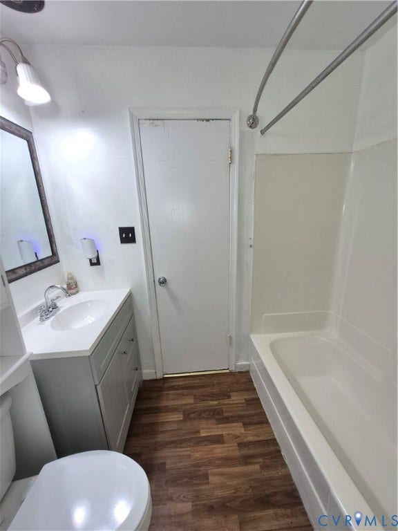 9324 Shiloh Drive, Chesterfield, VA 23237 Bathroom featuring a full-sized tub with shower, single vanity with integrated sink, wood-finish flooring, and wall-mounted light fixture