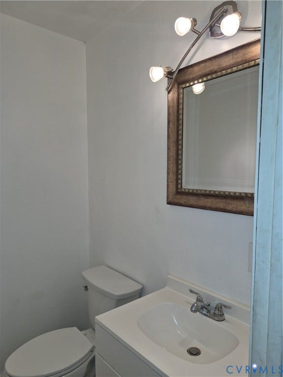 9324 Shiloh Drive, Chesterfield, VA 23237 White vanity with an integrated sink and chrome faucet
