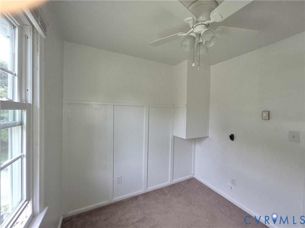 9324 Shiloh Drive, Chesterfield, VA 23237 Room featuring board and batten paneling, ceiling fan with integrated lighting, and a double-hung window